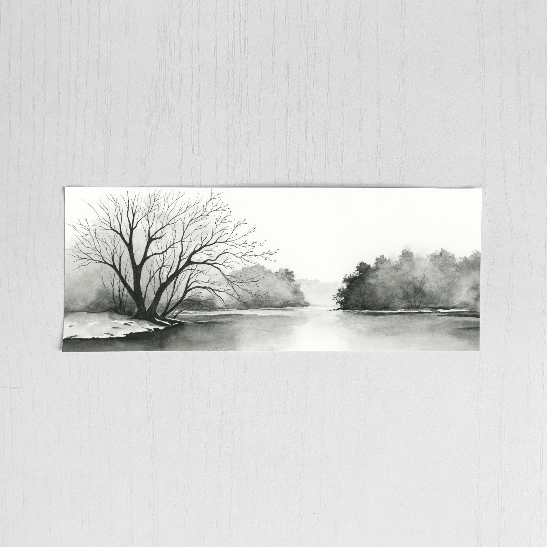 Black and white landscape painting of a river with trees on a textured wall.